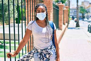 Stock image of young woman wearing a face mask.